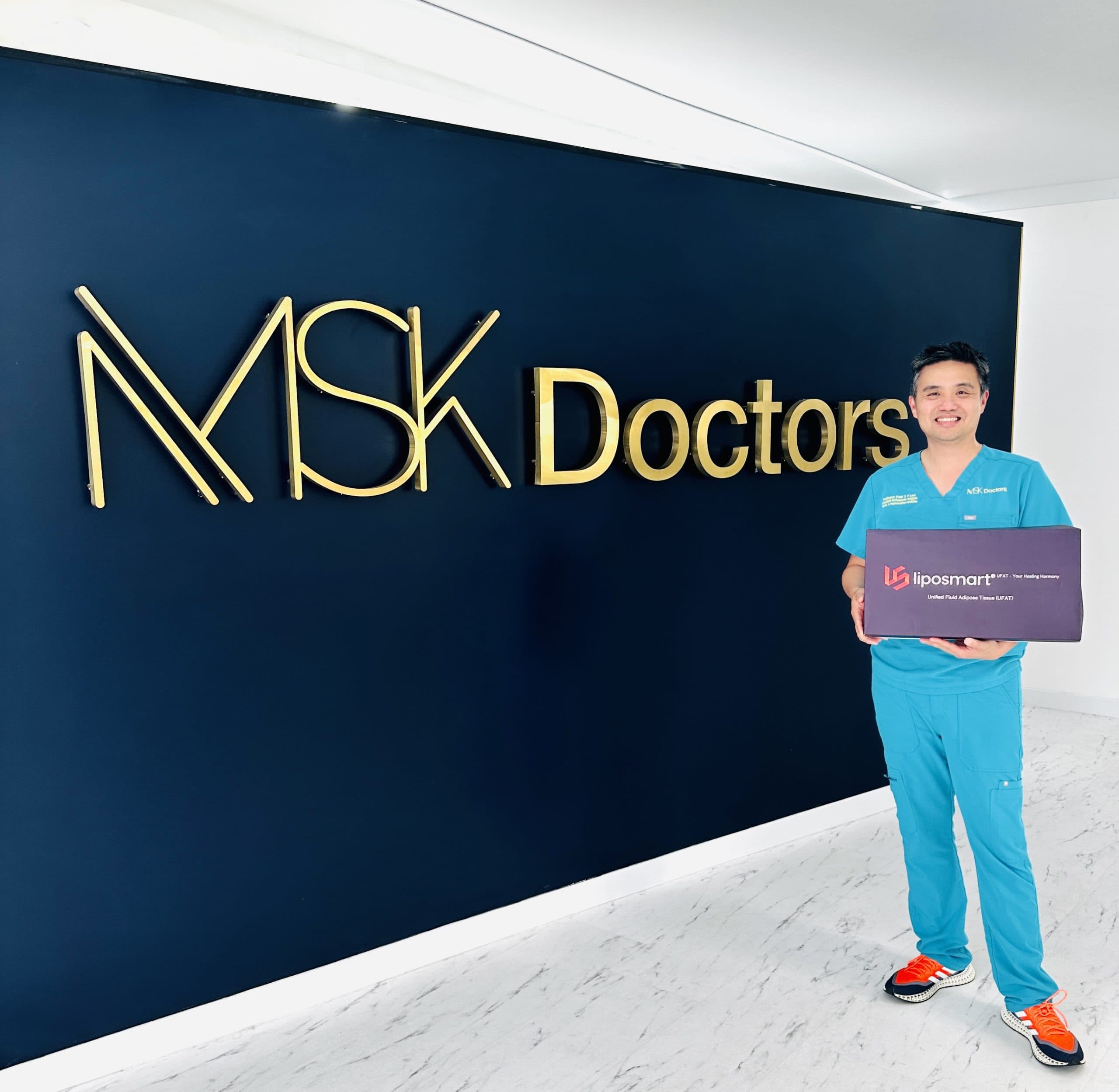 Surgeon standing at MSK Doctors wall