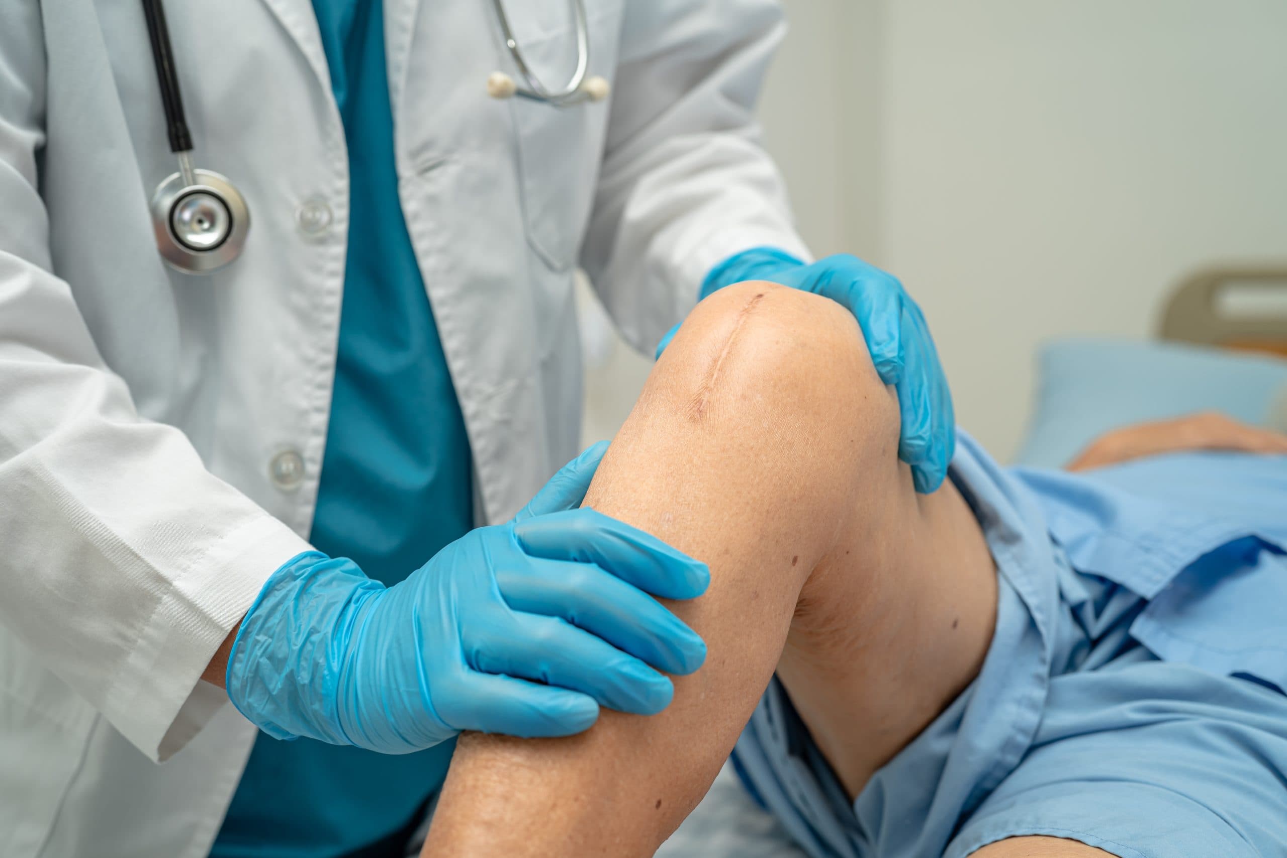 Doctor examining knee during follow-up