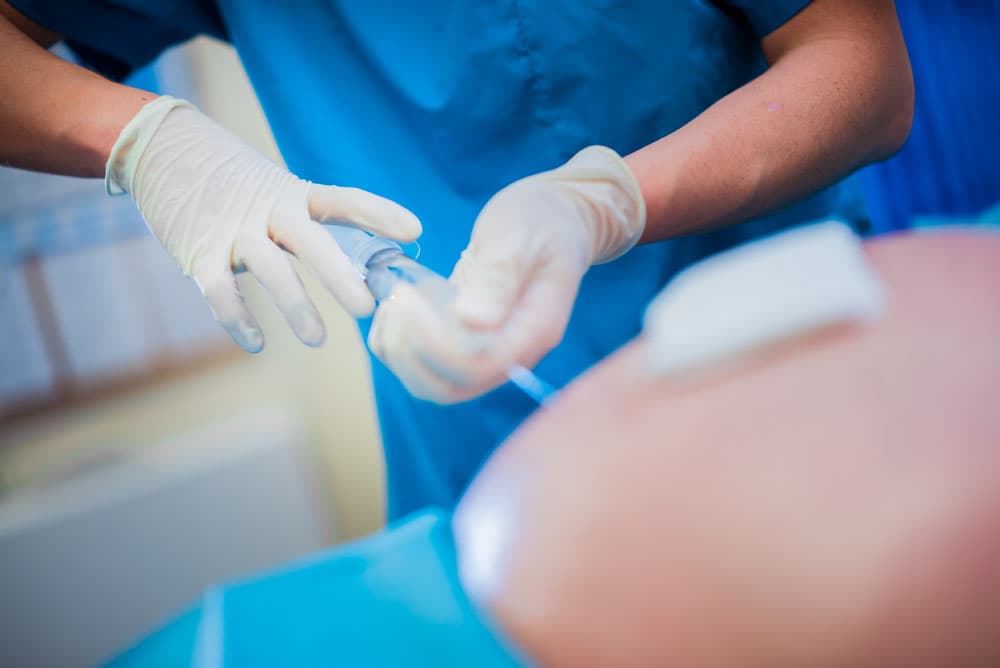 Sterile injection preparation in a blue clinical setting