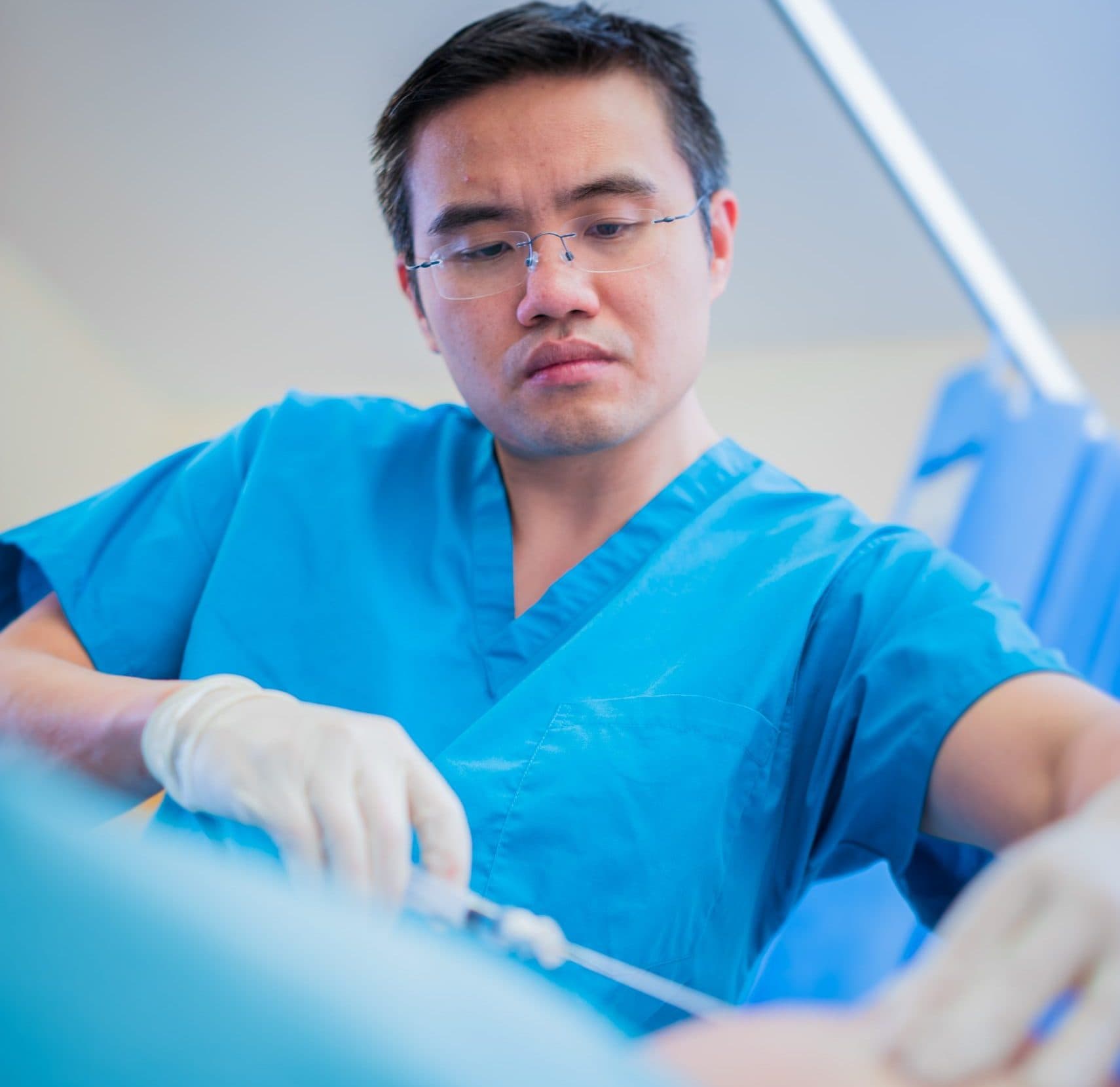 Surgical team performing matrix-assisted cartilage cell implantation