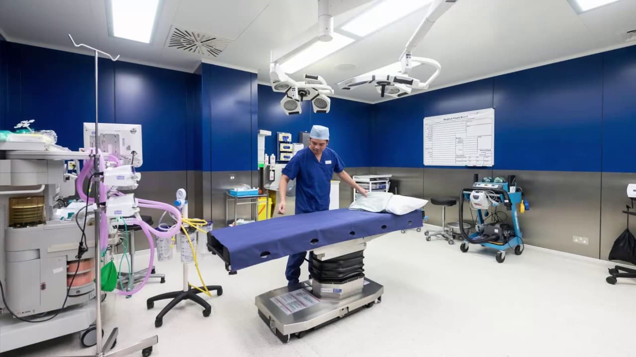 Blue operating room setup with surgical table
